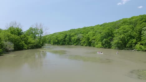A-couple-groups-of-people-kayaking-in-the-Illinois-and-Michigan-canal-next-to-the-Des-Plaines-river-on-a-warm-and-sunny-afternoon