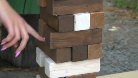 Girls-playing-tumble-tower,-playing-the-wooden-blocks-tower