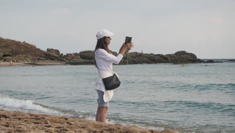 Woman-filming-sea-water