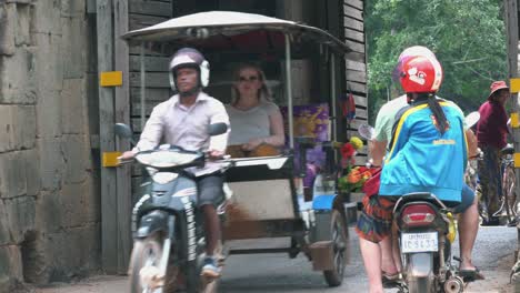 Motorbike-and-Tuk-Tuk-Passing-Through-a-Gate-at-Angkor-Wat