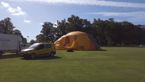 Team-of-hot-air-balloon-engineers-erect-inflate-their-balloons-for-a-tethered-display-at-a-Hot-Air-Balloon-festival