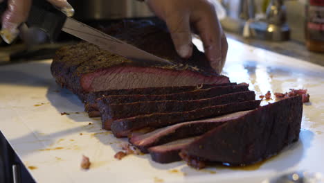 A-man-slices-a-brisket-for-a-BBQ-Cook-Off