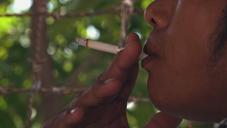 Shot-of-an-Asian-Male-Smoking-a-Cigarette