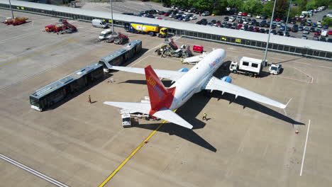 Tracking-shot-of-a-Sunwing-airplane-taxiing-to-its-arrival-terminal-gate