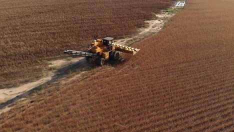 Aerial-view-following-a-havester-going-to-the-next-spot-to-start-picking-corn