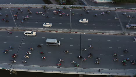 Hi-aerial-fast-panning-view-from-high-angle-of-evening-traffic-over-Dien-Bien-Phu-Bridge,-Binh-Thanh-district,-Ho-Chi-Minh-City,-Vietnam-which-crosses-the-Hoang-Sa-canal