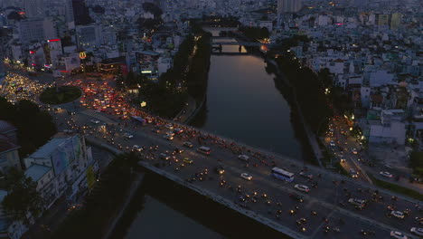 Evening-sunset-high-angle-drone-footage-looking-over-Dien-Bien-Phu-Bridge-the-Hoang-Sa-canal-area-of-Binh-Thanh-district,-Saigon-or-Ho-Chi-Minh-City,-Vietnam