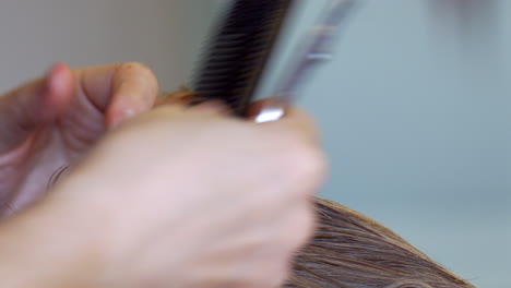 CLOSE-UP-Young-Blonde-Boy-Receiving-A-Haircut-With-Scissors