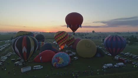 Aerial-View-of-Hot-Air-Balloons-Filling-Up-and-Taking-Off-at-a-Hot-Air-Balloon-Festival-on-a-Summer-Morning