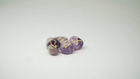 Five-Beautiful-Purple-Stones-With-Yellow-Mark-On-The-Top-Rotating-in-Circular-Motion---Close-Up-Shot