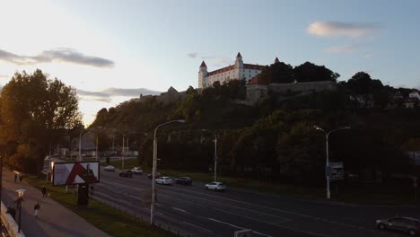Bratislava-Castle-overlooks-traffic-and-the-Danube-River-at-sunset