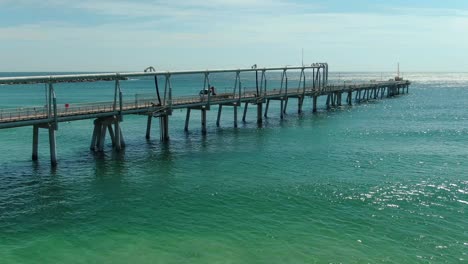 Flying-slowly-adjacent-to-the-Gold-Coasts-sand-pumping-jetty,-the-only-permanent-facility-of-its-king-in-Australia