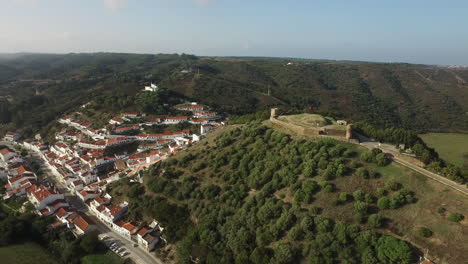 Aerial-view-of-a-portuguese-historical-castle-on-the-top-of-the-village-hill