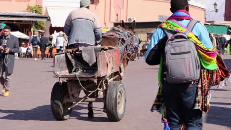Donkey-pulling-a-makeshift-labors-cart-through-the-streets-of-Marrakech-Morocco