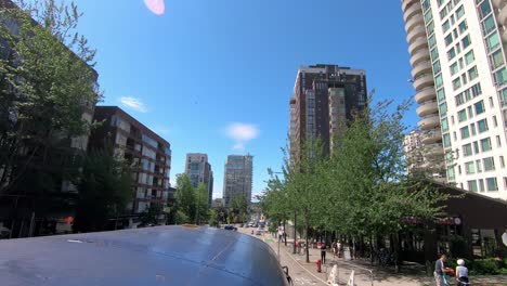 POV-from-the-top-of-a-tour-bus-while-driving-on-Burrard-Street-in-downtown-Vancouver-near-False-Creek-on-a-bright-summer-day