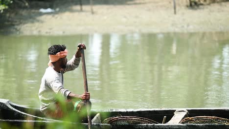 Indian-fisherman-in-boat-rowing-in-river-outside-Bangalore