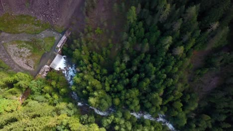 Dolomite-park-Italy-seen-from-above-with-small-man-made-dam-used-to-alter-the-flow-of-a-river,-Aerial-drone-top-view-reveal-shot