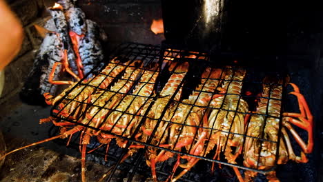 Crayfish-on-open-fire-being-dressed-with-garlic-butter-and-barbecued-on-open-fire