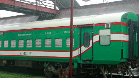 Stationary-Dhaka-Intercity-railway-carriage-parked-on-siding-during-rain