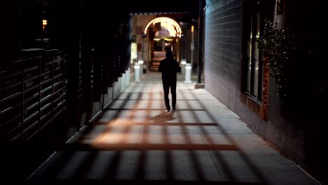 Man-walking-in-the-street-at-night