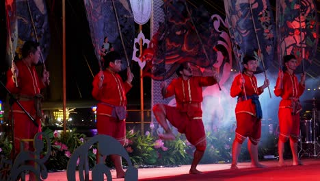 Fünf-Männer-Auf-Der-Bühne,-Von-Denen-Einer-Während-Eines-Schattenspiels-Am-Loi-Krathong-Urlaub-In-Thailand-Einen-Tanz-Aufführt
