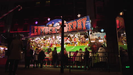People-play-midway-games-and-enjoy-amusement-park-attractions-while-visiting-at-night