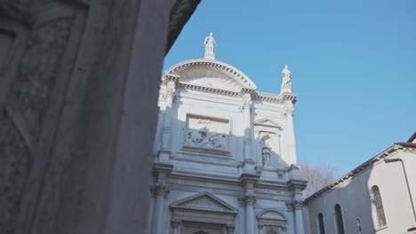 Artistic-details-on-the-white-facade-of-San-Rocco-church,-Venice,-Italy