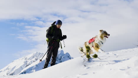 Girl-with-dog-in-winter-mountains.-Mountaineering,-adventure
