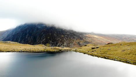 Aerial-footage-of-rock-formation-and-lake-at-Cwm-Idwal,-Snowdonia-National-Park,-Wales,-UK