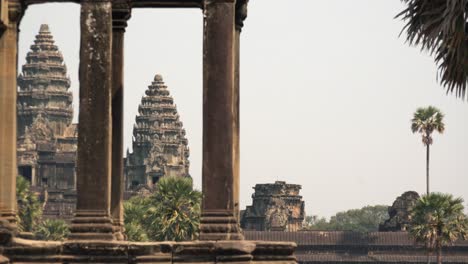 Medium-Exterior-Timelapse-Shot-of-Angkor-Wat-Towers-Through-Column