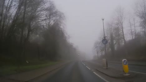 POV-dashboard-driving-in-British-fog-weather-urban-countryside-road-traffic