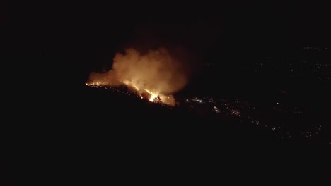 Forest-Fire-in-background-of-night-sky,-smoke-illuminated-in-dark-scene-4k