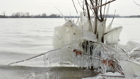 Low-shot-of-lake-with-frozen-shore-with-Ice