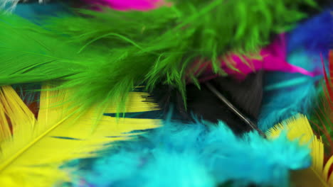 Rotating-pile-of-delicate,-soft,-multicolored-feathers