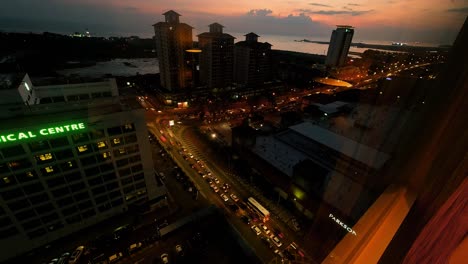 Aerial-of-busy-street-in-Malacca-City-in-Malaysia-at-dusk,-long-exposure