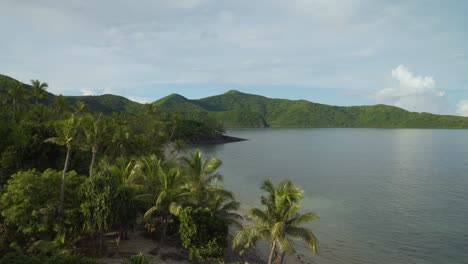 Blissful-landscape-with-calm-ocean-waters-and-rich-green-jungle-on-its-shore