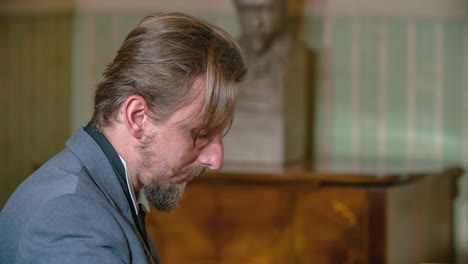 Close-Up-Shot-Of-The-Face-Of-A-Classical-Music-Composer-As-He-Plays-The-Piano