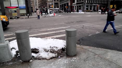 People-crossing-the-streets-of-the-Financial-district,-downtown-New-York-City-during-the-Winter