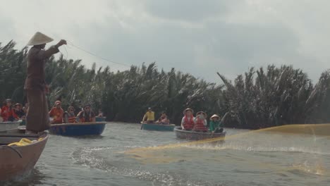 Hombre-Vietnamita-Pescando-Con-Una-Atarraya-En-Un-Río-Lleno-De-Gente