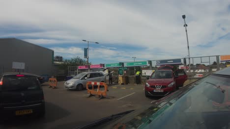 POV-From-Outside-Car-Slowly-Moving-To-Exit-Waste-Recycling-Centre-In-Harrow,-UK