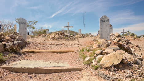 Tourists-paying-respects-to-the-people-buried-at-the-Boothill-Cemetery-in-Tombstone,-Arizona---wide-pan