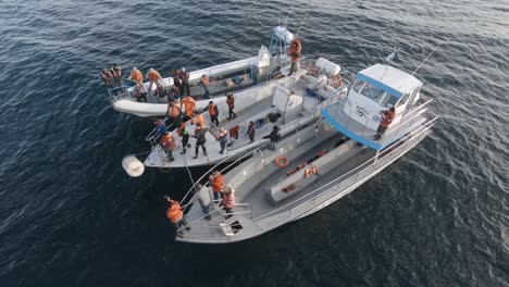 Nautical-training,-man-releasing-a-lifeboat-container-in-the-Patagonian-sea---slow-motion