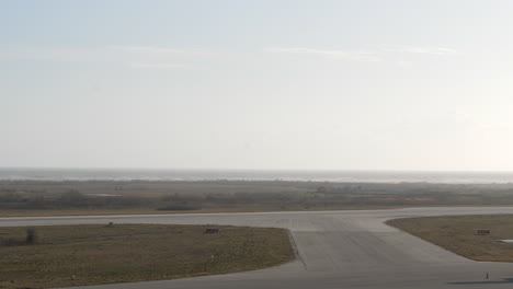 Wide-angle-view-of-a-chinook-helicopter-taking-off-from-a-runway-on-a-bright-day-at-Alexandroupolis-airport