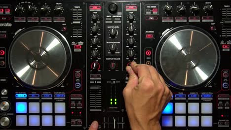 DJ-Mixing-Music-with-Digital-Controller-Turning-Knobs-overhead-Party