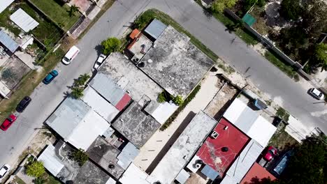 Aerial-drone-rising-and-looking-straight-down-onto-a-small-poor-neighbourhood-in-a-small-town-in-Quintana-Roo,-Mexico---Bacalar