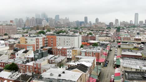 South-Philly-neighborhood,-aerial-of-colorful-buildings-and-Italian-community,-Philadelphia-skyline-on-summer-cloudy-rainy-day