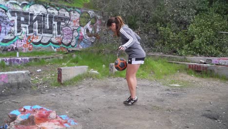 Athletic-girl-doing-soccer-tricks-and-skills-with-soccer-ball-outside