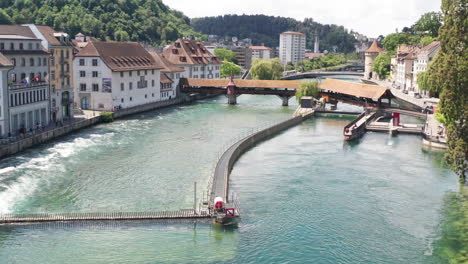 Aerial-of-beautiful-canal-in-Luzern,-Switzerland---drone-setting-down