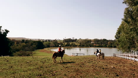 Three-young-people-enjoying-horseback-riding-lessons-int-he-paddocks