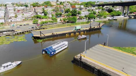 Toma-Aerea-Con-Drone,-Del-Interceptor-004,-Cruzando-El-Rio-Ozama-Con-Vista-Al-Puente-Flotante